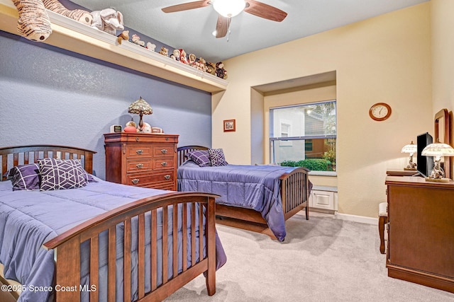 bedroom with baseboards, a ceiling fan, and light colored carpet