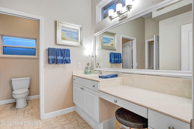 full bathroom featuring toilet, baseboards, and vanity