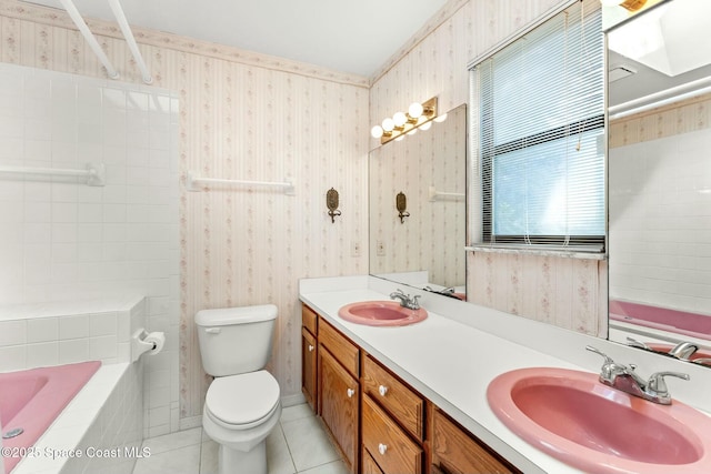 bathroom featuring toilet, vanity, tile patterned flooring, and a bathtub