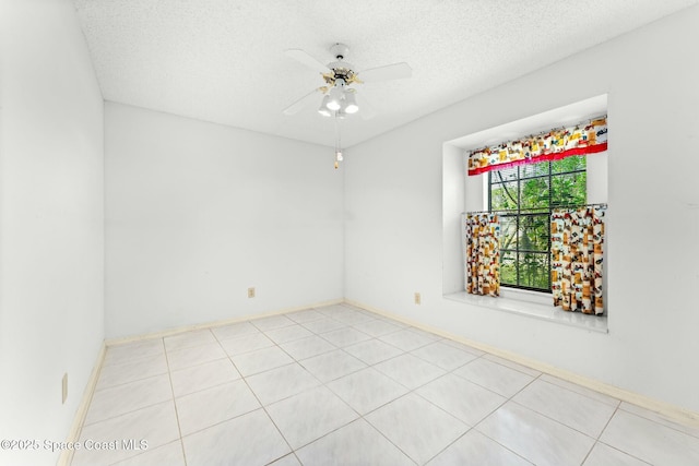 unfurnished room with ceiling fan and a textured ceiling