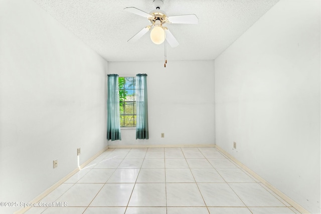 tiled spare room with ceiling fan and a textured ceiling