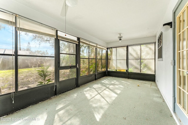 unfurnished sunroom featuring ceiling fan