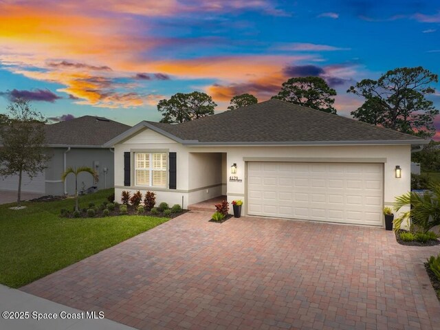 4179 Keeson Cir, Vero Beach, FL 32967 - single story home featuring a yard, decorative driveway, an attached garage, and stucco siding