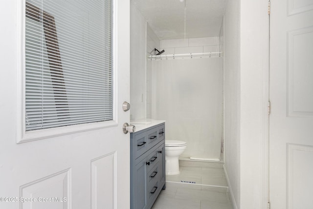 full bath with vanity, tile patterned flooring, toilet, and a stall shower