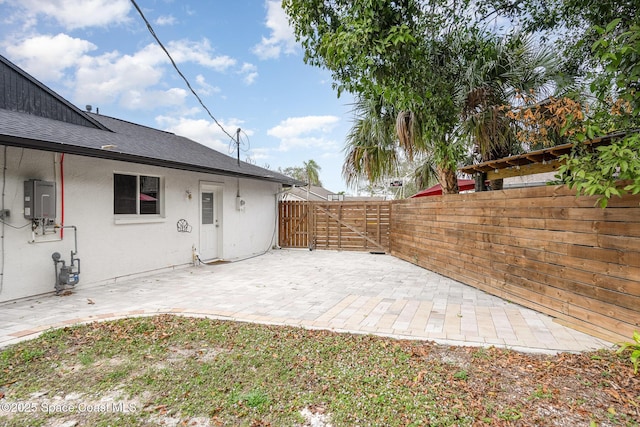 view of patio with fence and a gate