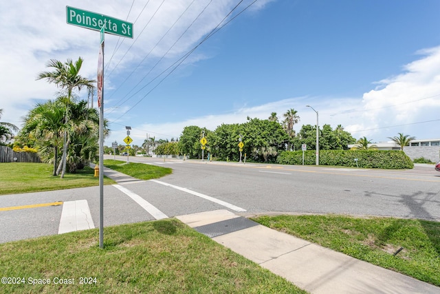 view of road with sidewalks and traffic signs