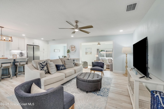 122 Poinsetta St, Indialantic, FL 32903 - living room with ceiling fan, light wood-style flooring, and recessed lighting