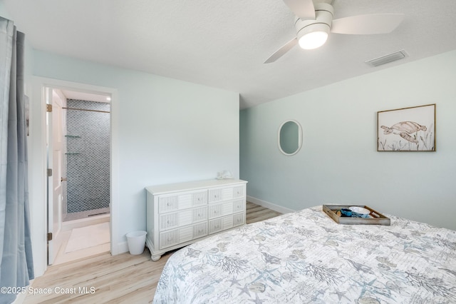 122 Poinsetta St, Indialantic, FL 32903 - bedroom with light wood-style floors, ensuite bathroom, and ceiling fan