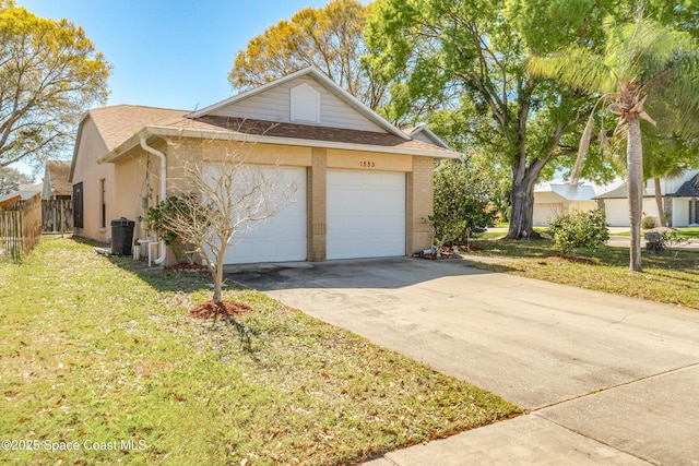 exterior space featuring a lawn and a garage