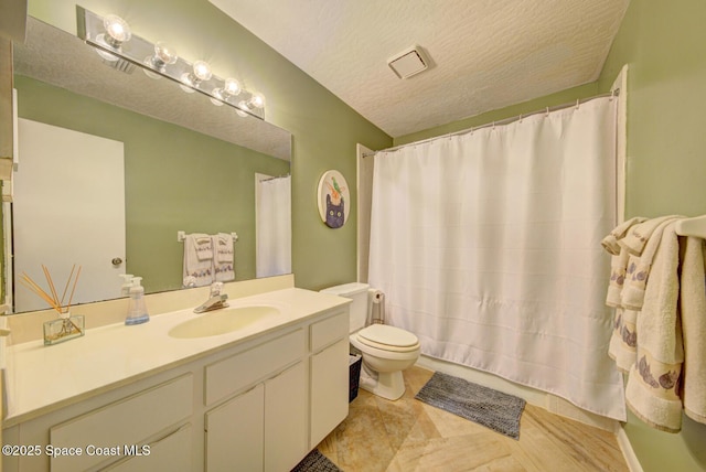 full bathroom with a textured ceiling, toilet, vanity, and curtained shower