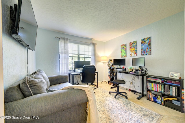 home office with a textured ceiling and a textured wall