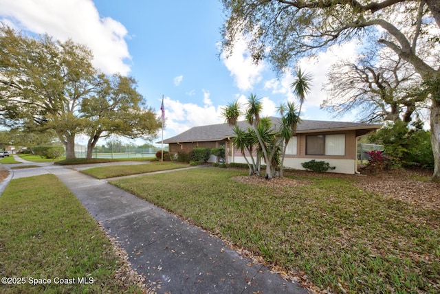 view of front of house featuring a front lawn, fence, and stucco siding