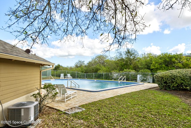 view of pool featuring central AC unit, a fenced in pool, a lawn, fence, and a patio area