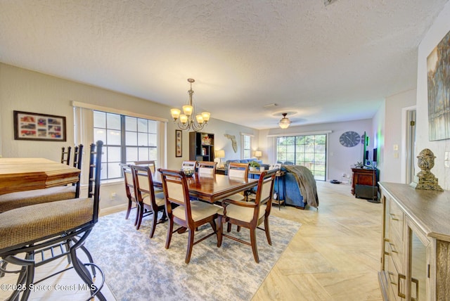 dining area featuring a textured ceiling and an inviting chandelier