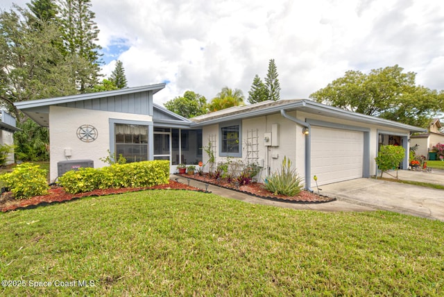 view of front of property featuring a garage, driveway, central AC unit, and a front yard