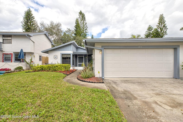 view of front of home featuring a front yard, concrete driveway, and an attached garage