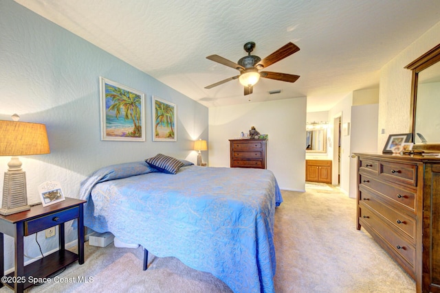 bedroom featuring light carpet, a textured wall, and a textured ceiling