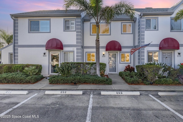 multi unit property with uncovered parking and stucco siding