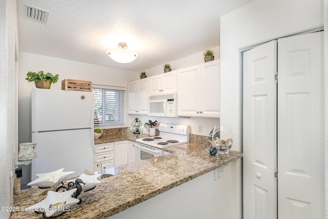 kitchen featuring a textured ceiling, white appliances, white cabinetry, visible vents, and light stone countertops