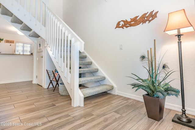 stairs featuring baseboards and wood finished floors