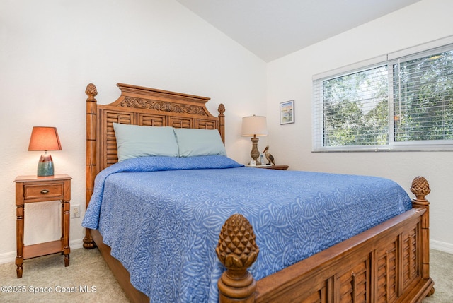 bedroom featuring light carpet, baseboards, and lofted ceiling