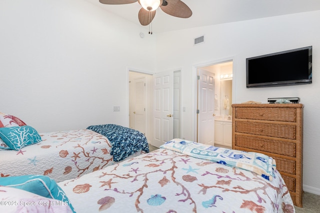 carpeted bedroom with lofted ceiling, connected bathroom, visible vents, and a ceiling fan