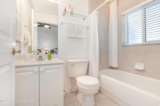 full bath with tile patterned flooring, toilet, shower / tub combo, vanity, and a ceiling fan