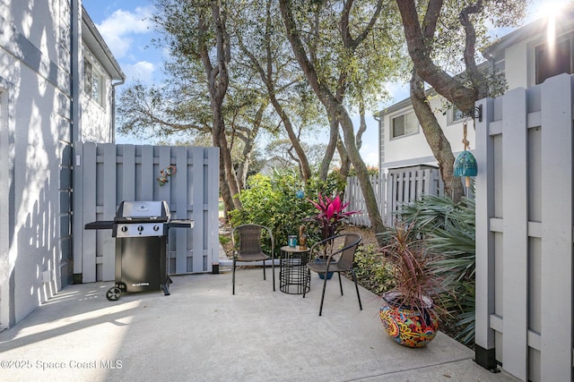 view of patio / terrace featuring fence and grilling area