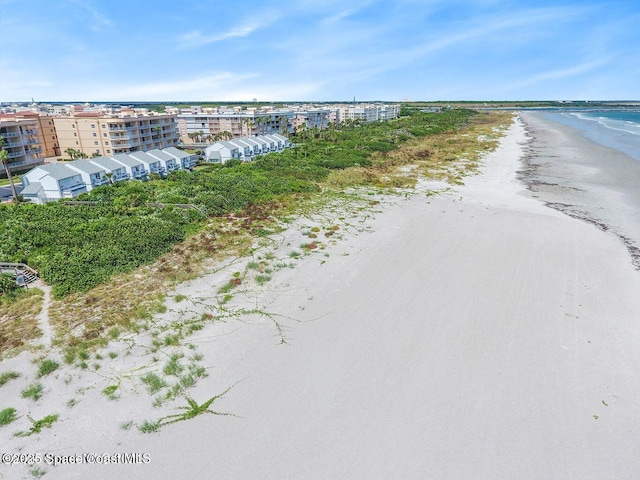 drone / aerial view featuring a water view and a beach view