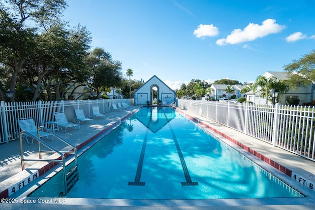 community pool featuring a patio area and fence