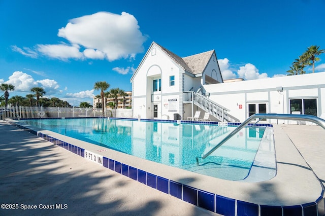 pool with fence and stairway