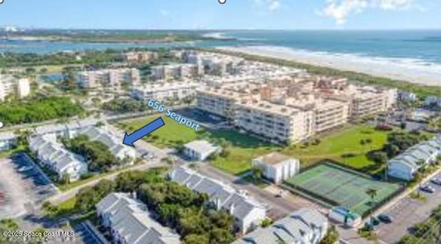 drone / aerial view featuring a water view and a beach view