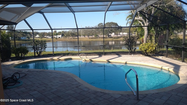 view of swimming pool featuring a water view, a patio area, a lanai, and a fenced in pool