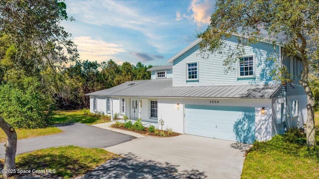 view of front of property with covered porch and a garage