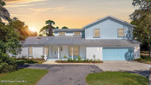 view of front of home with covered porch and a garage