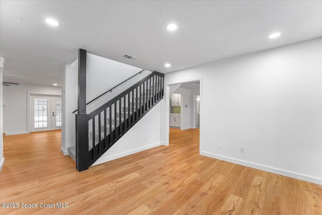 interior space with hardwood / wood-style flooring and a textured ceiling