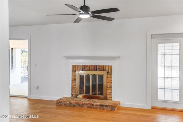 unfurnished living room with wood-type flooring and a fireplace