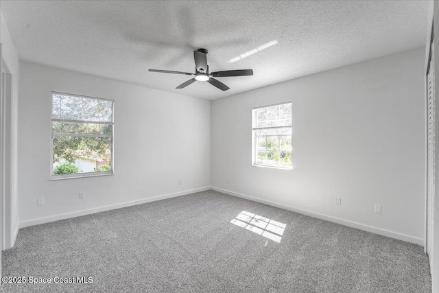 unfurnished room featuring carpet floors, a textured ceiling, and ceiling fan