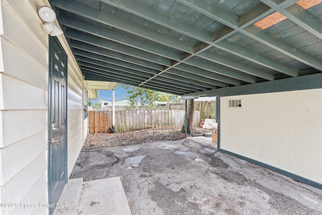 view of patio featuring visible vents and fence