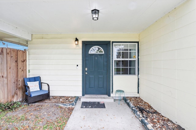 view of exterior entry featuring concrete block siding