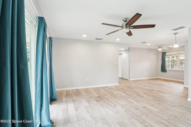 unfurnished room featuring baseboards, light wood finished floors, visible vents, and recessed lighting