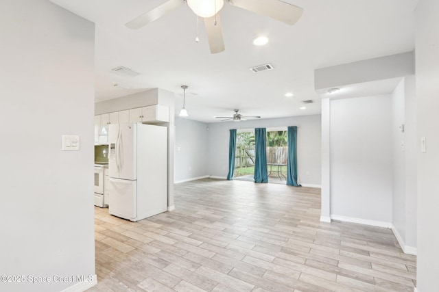 spare room with baseboards, recessed lighting, visible vents, and light wood-style floors