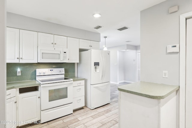 kitchen with visible vents, white appliances, white cabinets, and decorative light fixtures