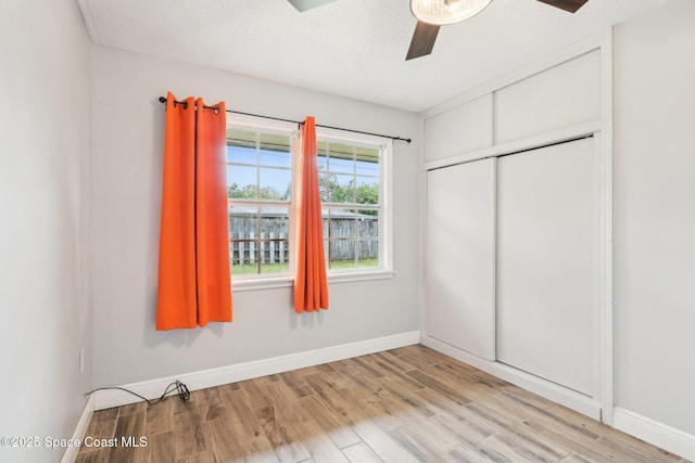 unfurnished bedroom featuring baseboards and light wood finished floors