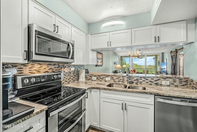 kitchen featuring white cabinetry, appliances with stainless steel finishes, and a sink