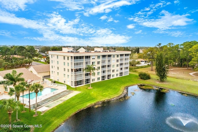 view of property featuring a water view and a community pool