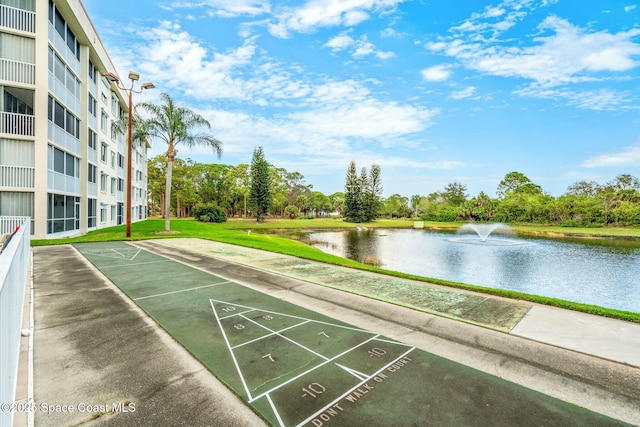 view of home's community with a water view and shuffleboard