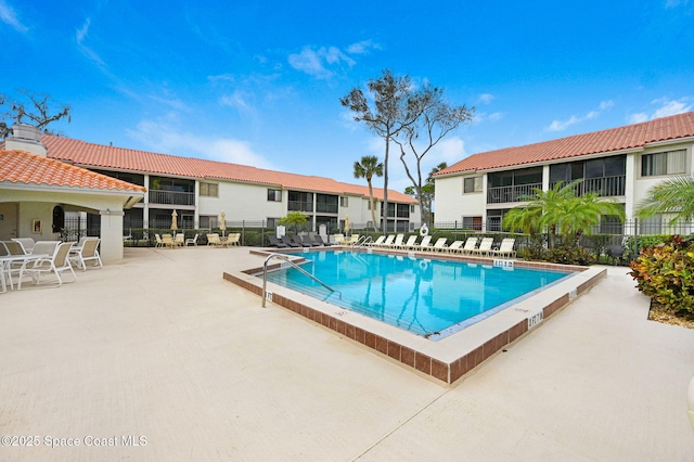 pool featuring fence and a patio