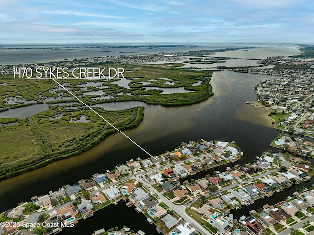 drone / aerial view with a water view and a residential view