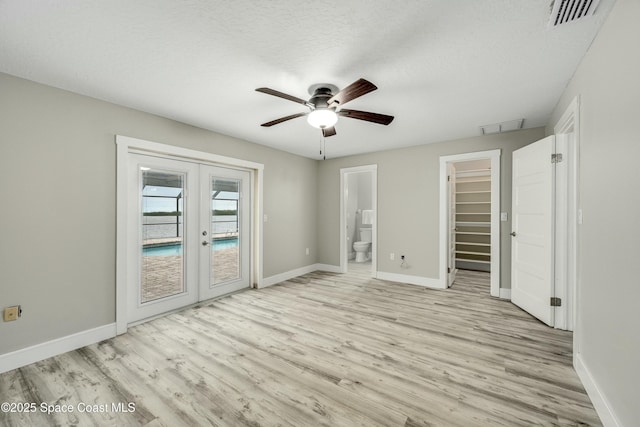 unfurnished bedroom with access to outside, french doors, light wood-type flooring, and visible vents